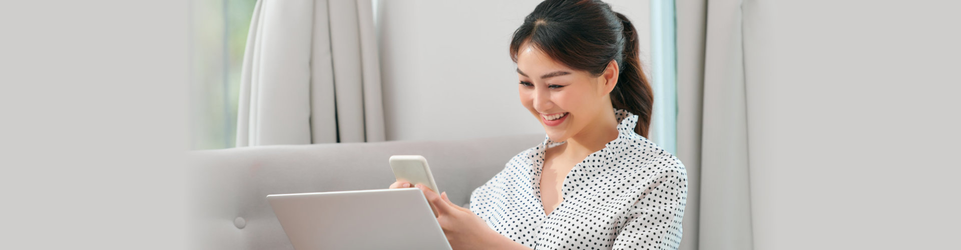 woman using mobile phone ang laptop